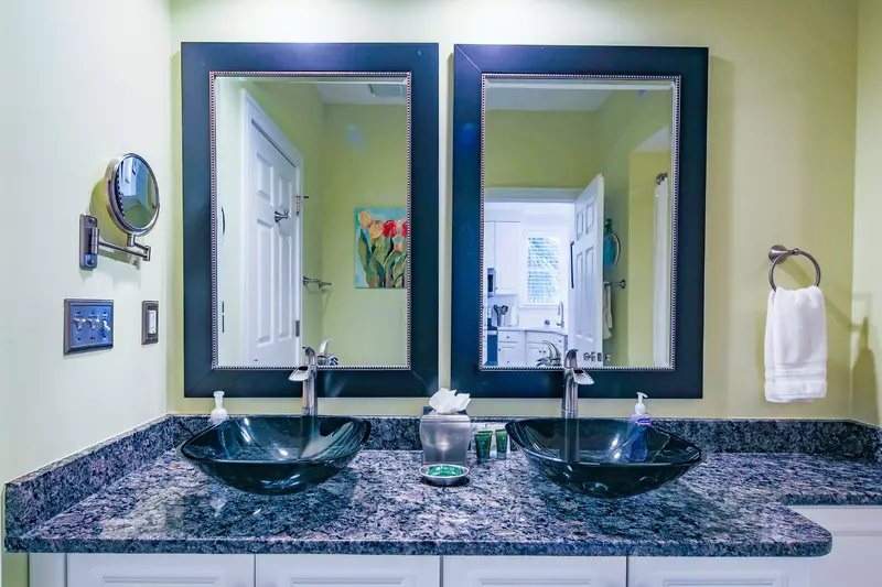 This bathroom has a large vanity with his & her sinks and plenty of storage area for your personal items.