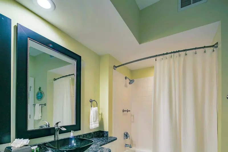 This bathroom also has a tiled shower/tub combo.