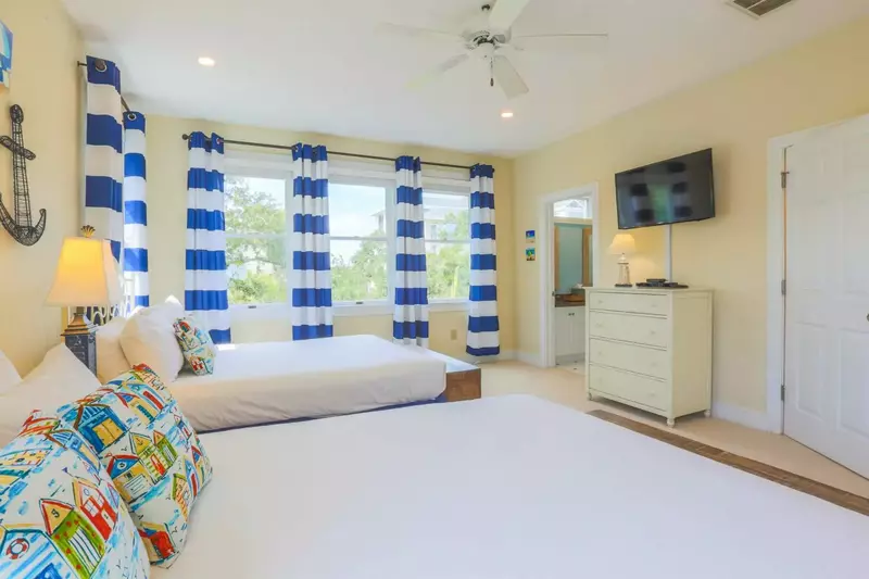 This queen suite has a mounted cable TV and en suite bathroom.
