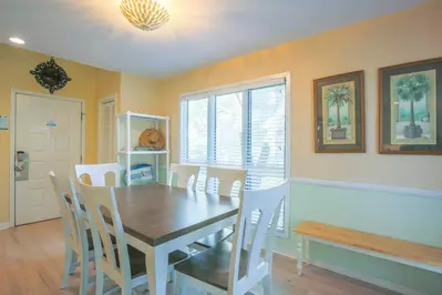 The front door opens onto the home's dining area with a dining table that seats 6.