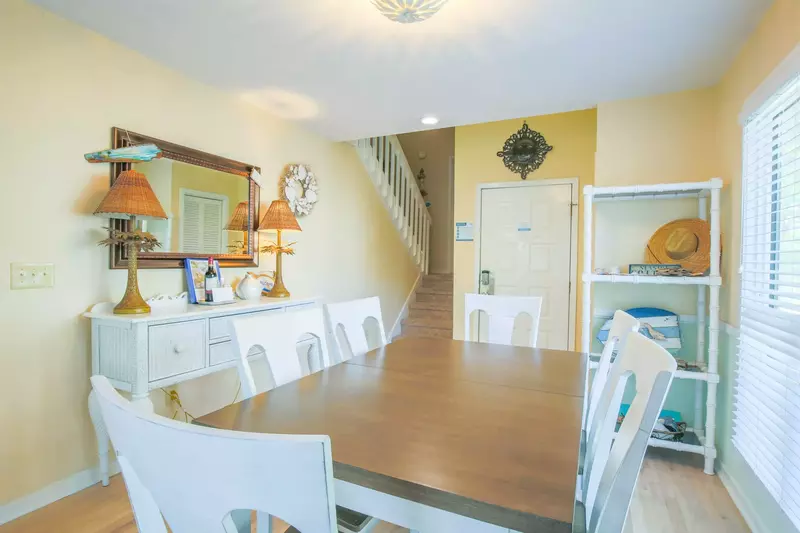 The staircase near the dining table and front door lead to the home's bedrooms & bathrooms.
