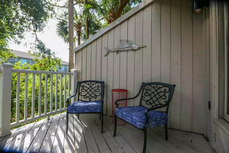 The balcony is surrounded by palmetto trees, live oak trees & other Lowcountry greenery.