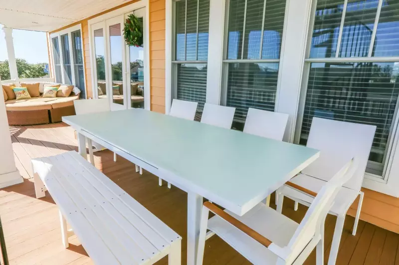 The French doors connect the dining room and living room areas to the covered back porch.