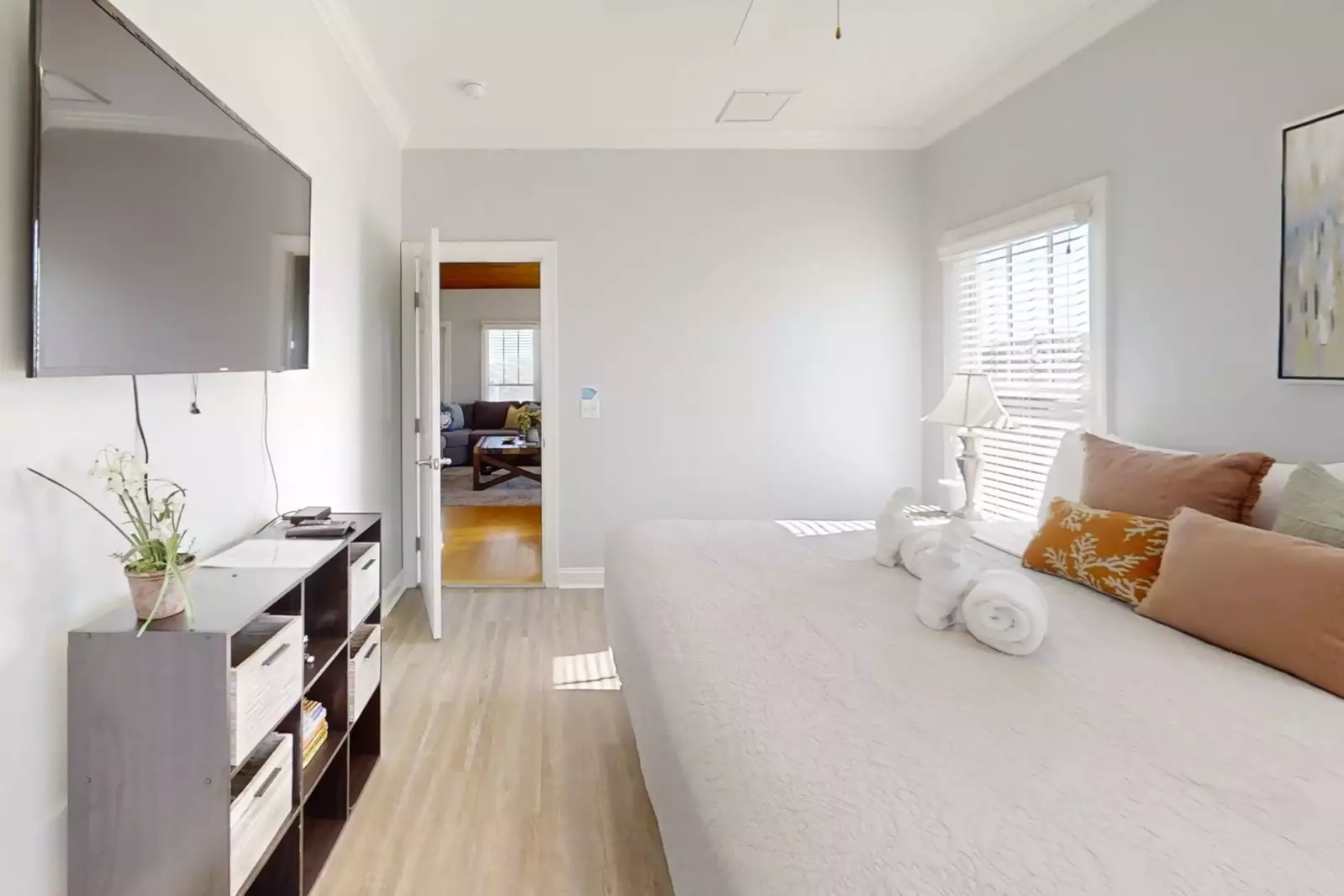 The primary suite also features a wall-mounted smart TV.