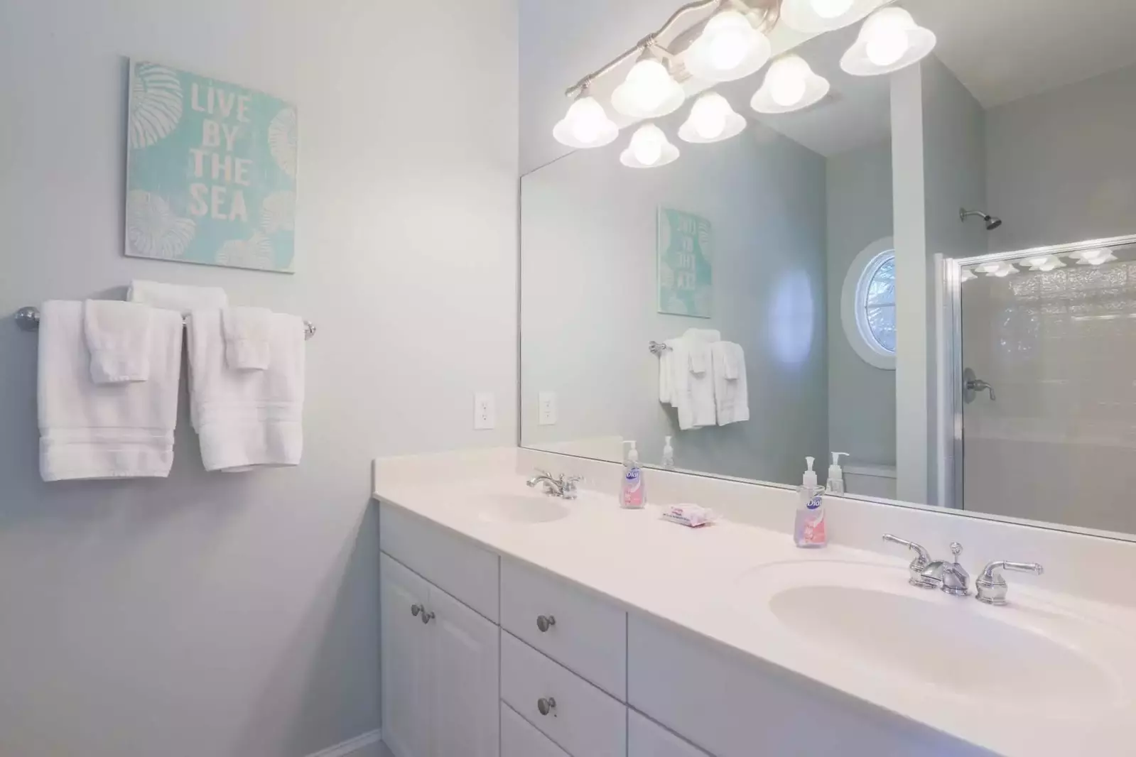 This en suite bathroom has a double sink vanity and tiled walk-in shower.