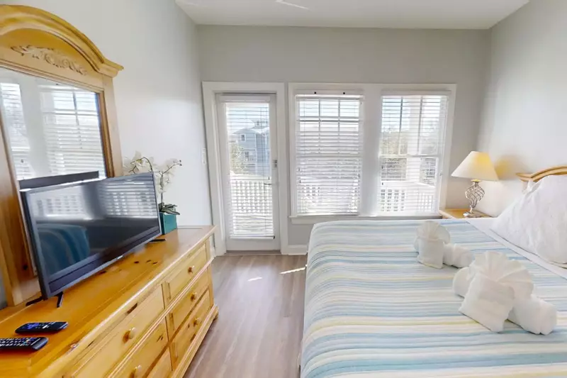 This guest suite also features access to the back deck and a dresser with smart TV.