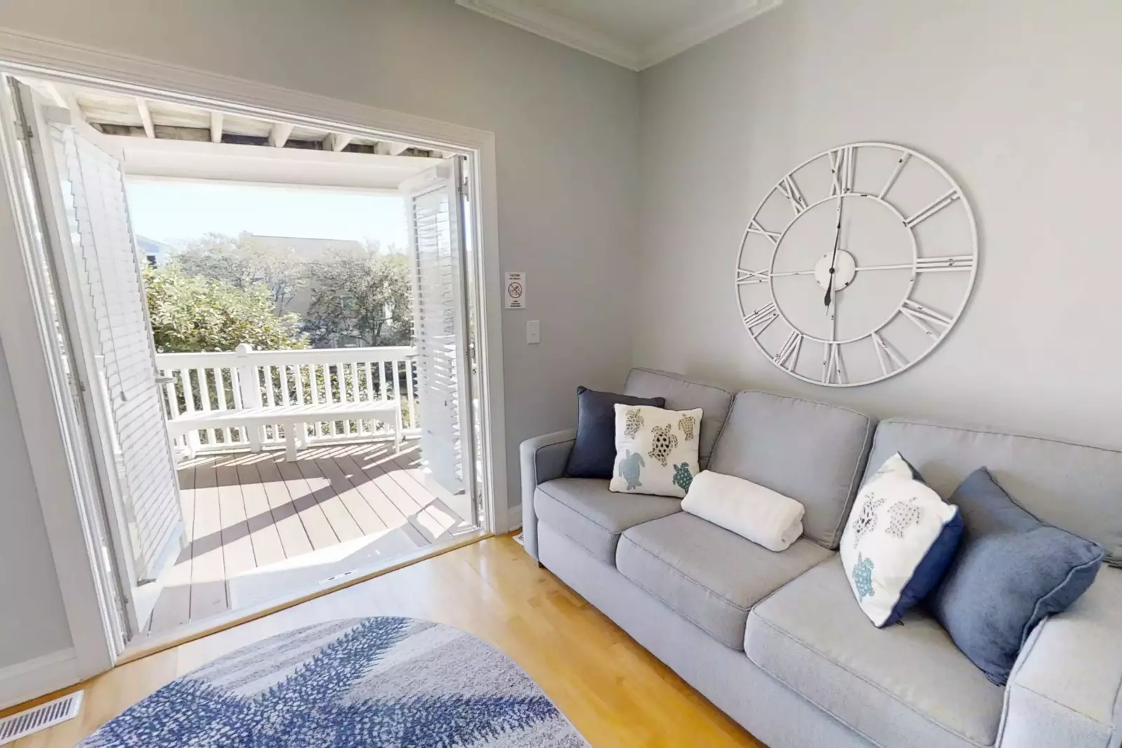 This den, which has a queen size sleeper sofa, accesses the covered deck on the first level of the home.