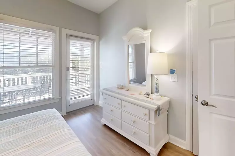 This guest suite also features a dresser and access to the back deck.