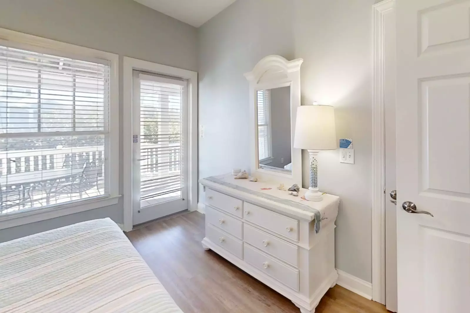 This guest suite also features a dresser and access to the back deck.