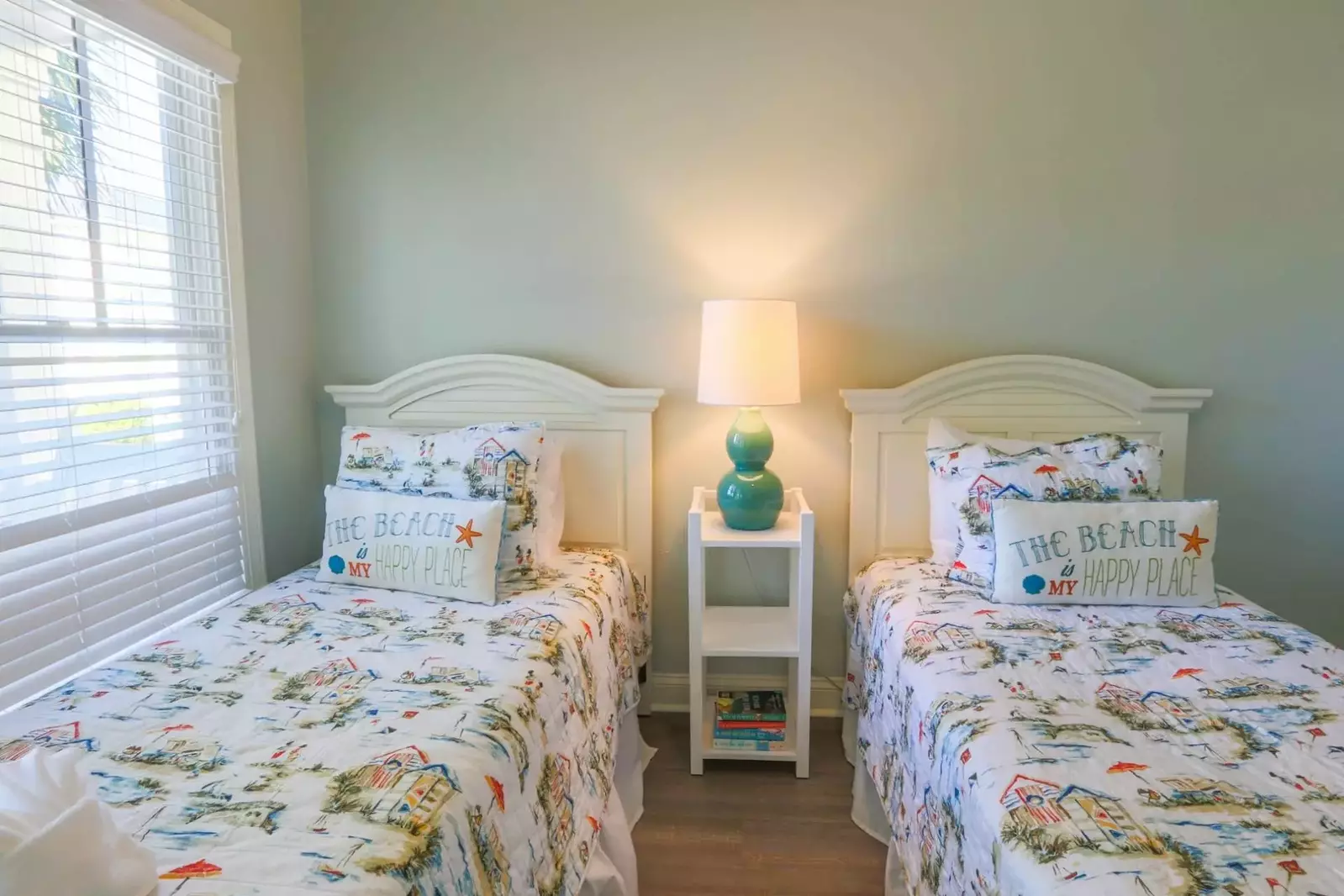 This guest suite on the lower level features two twin beds and a night stand with a reading lamp.