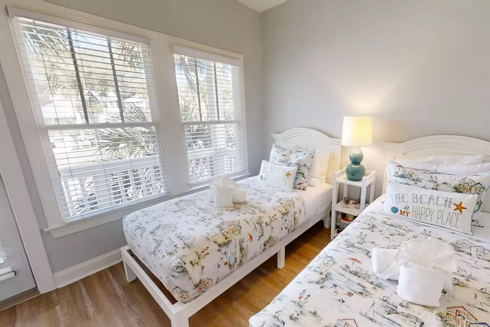 This guest suite looks out the front of the home and access the narrow front balcony.