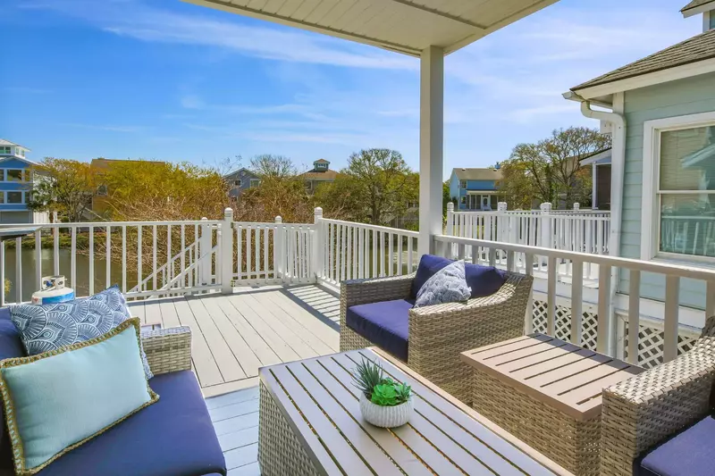 This partially-covered deck is accessible from the master suite and overlooks the lagoon behind the home.