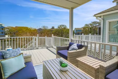This partially-covered deck is accessible from the master suite and overlooks the lagoon behind the home.