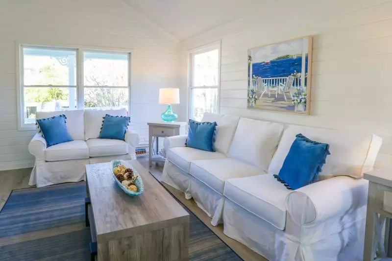 The living room features vaulted ceilings and shiplap walls.