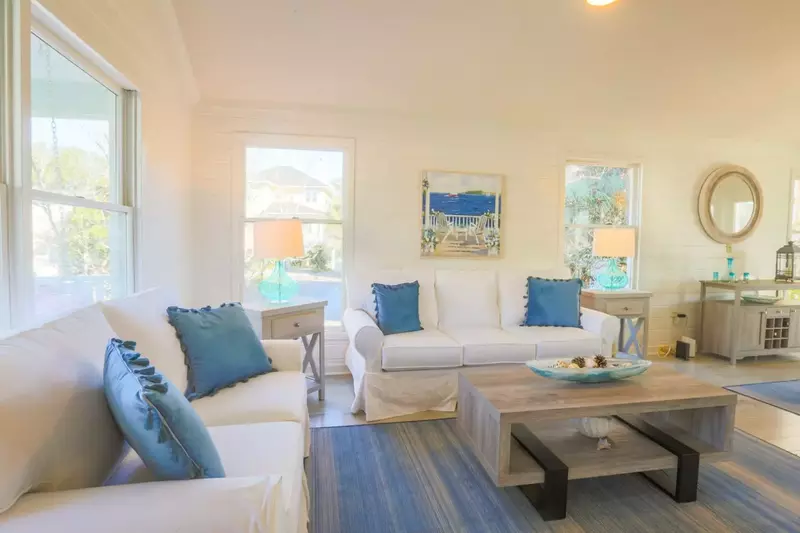 This renovated living room features new furniture, new rugs and new floors.