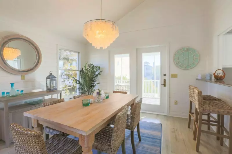 The French doors connect the dining room to the screened porch.