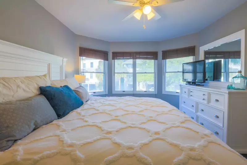 The master bedroom suite features a king bed and dresser with cable TV.
