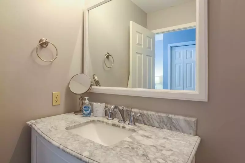 The master bedroom has an en suite bathroom with a spacious vanity and a shower/tub combo.