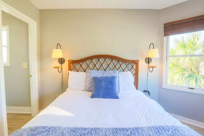 The en suite bathroom for this guest room is located just inside the doorway on the left side of this photo.