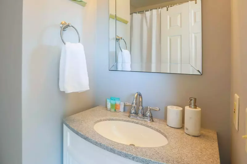 The en suite bathroom for this guest room features a spacious vanity and a shower/tub combo.