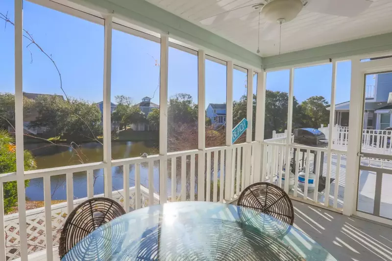 The screened porch has a dining table that seats 4 and wonderful views of the lagoon.