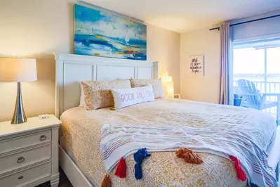 Both the master bedroom and living room feature terrific views of the Folly River.