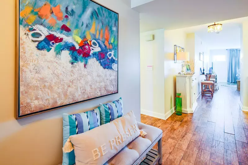 When you enter the home, you'll find this foyer that connects the hallway to the bedrooms to the living room and dining area.