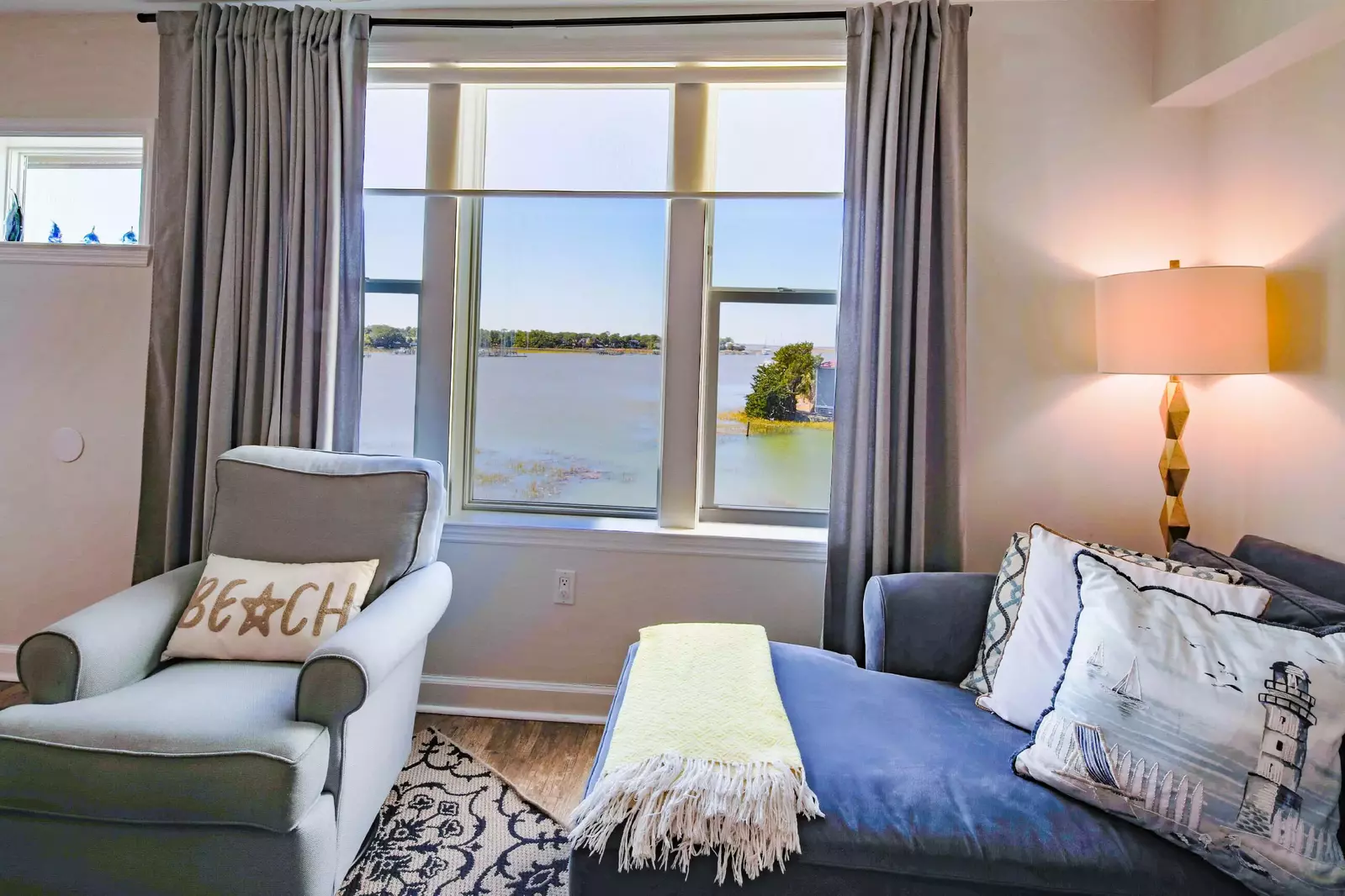The living room features mesmerizing views of the Folly River below.