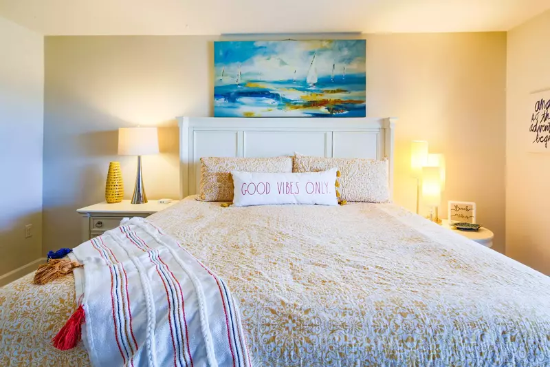 The master suite has a king bed and two night stands with reading lamps.