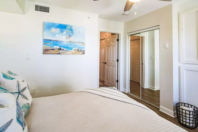 This guest bedroom has a mirrored closet.  The bathroom is located adjacent to this room and is accessible via the hallway.