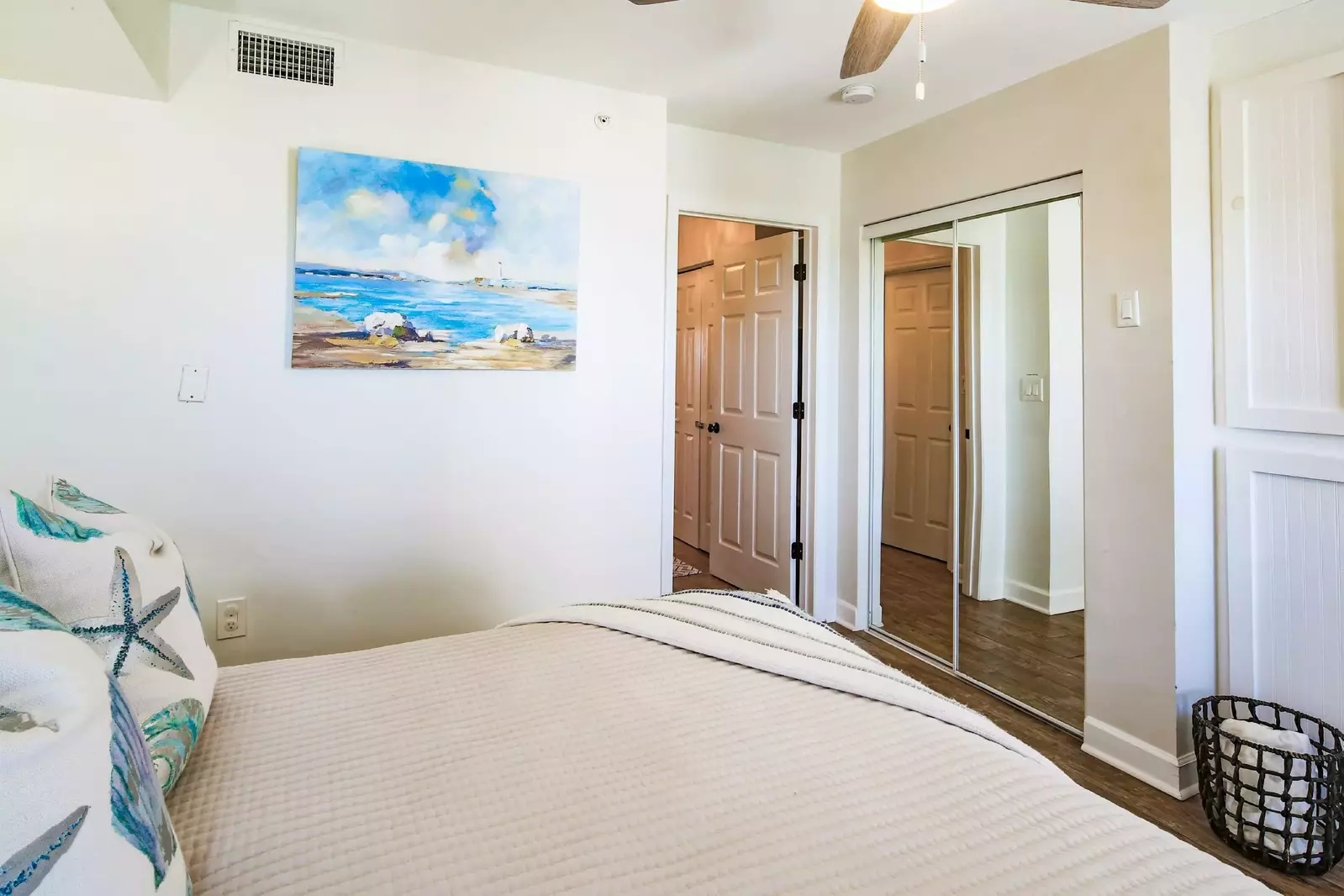 This guest bedroom has a mirrored closet.  The bathroom is located adjacent to this room and is accessible via the hallway.