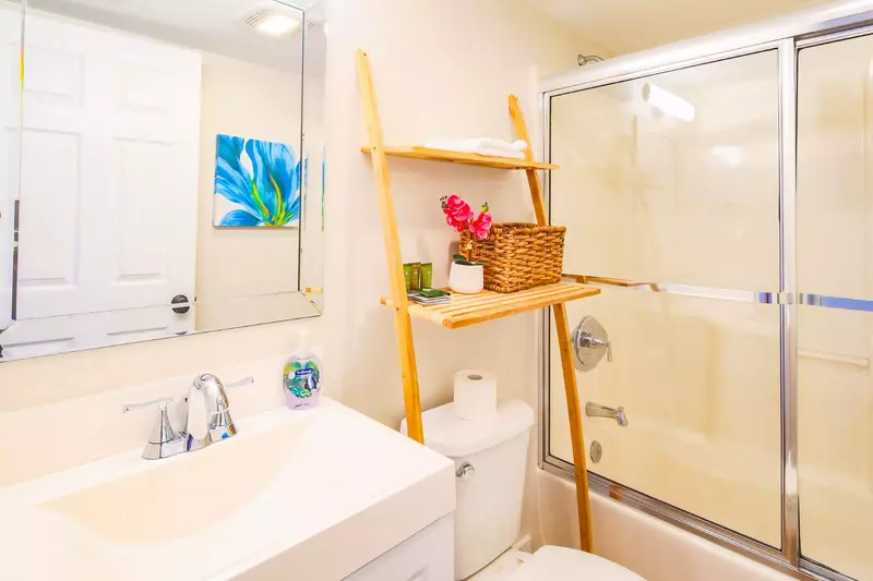 This bathroom, which is located off the hallway, has a shower/tub combo.