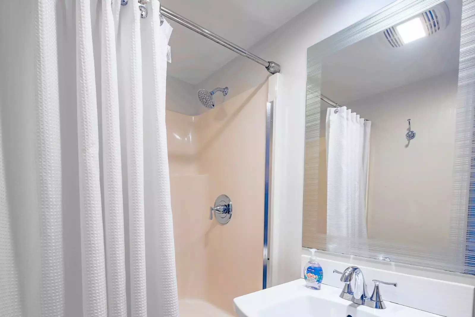 This en suite bathroom also has a walk-in shower.