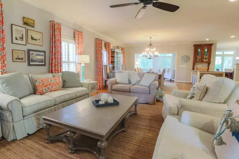 The living room opens onto the home's dining room, family room and kitchen areas.