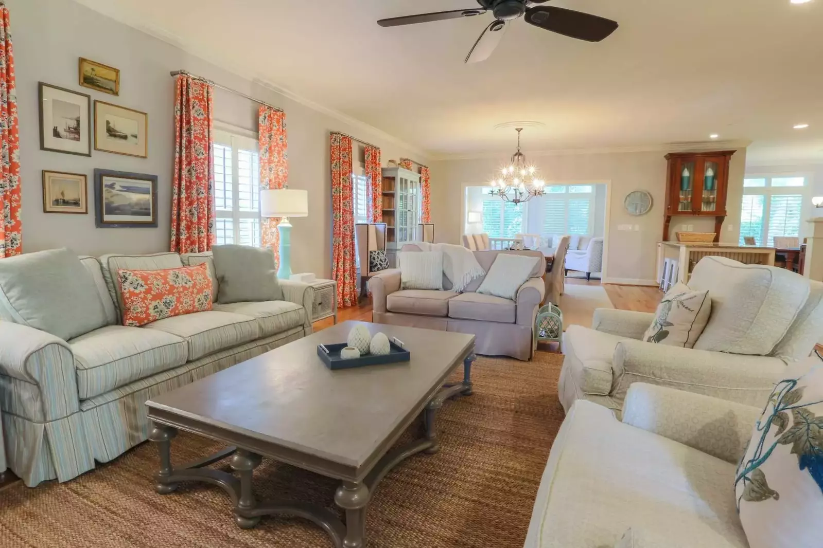 The living room opens onto the home's dining room, family room and kitchen areas.
