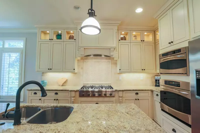 The kitchen features a double oven, gas cook top, dishwasher, refrigerator & more.