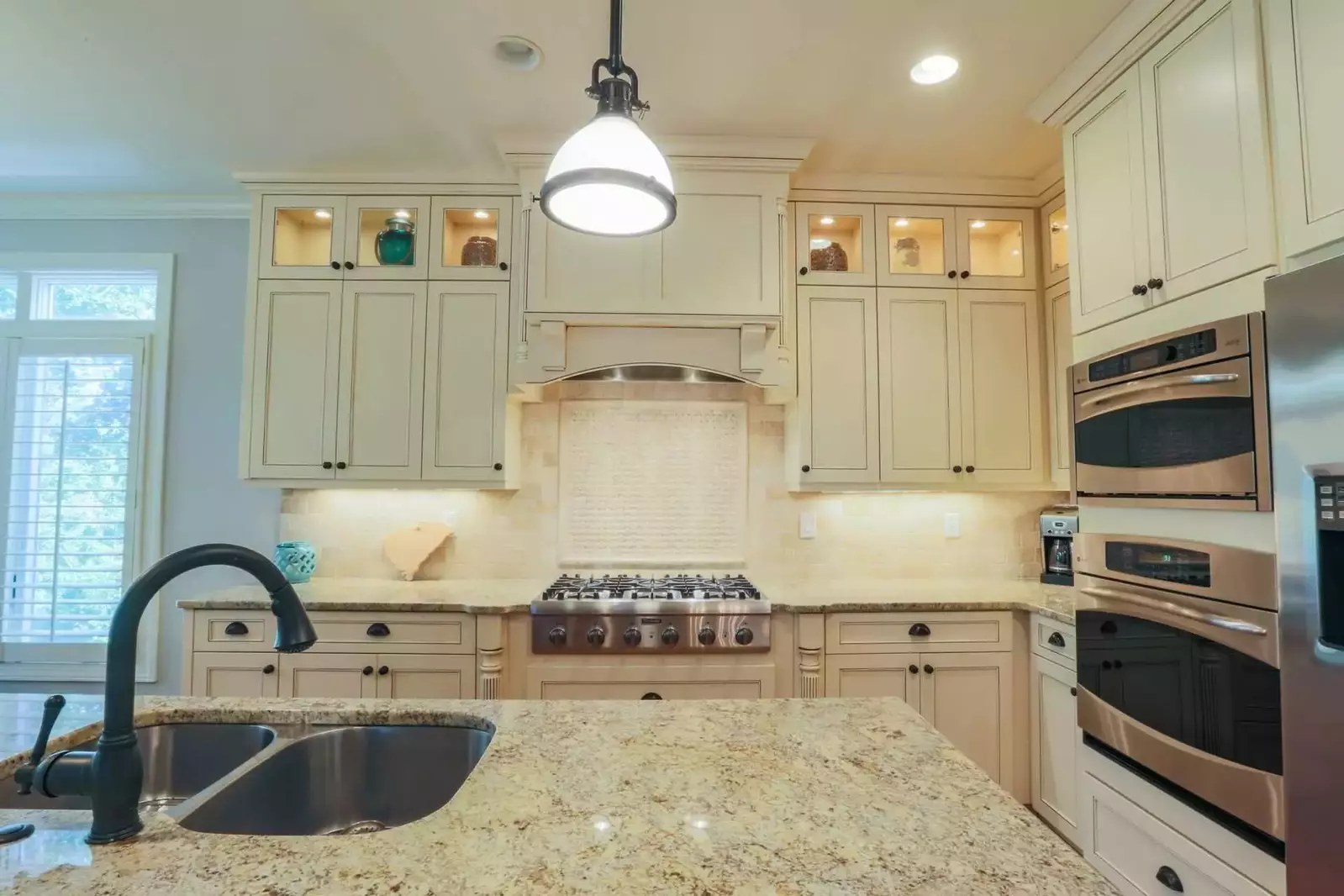 The kitchen features a double oven, gas cook top, dishwasher, refrigerator & more.
