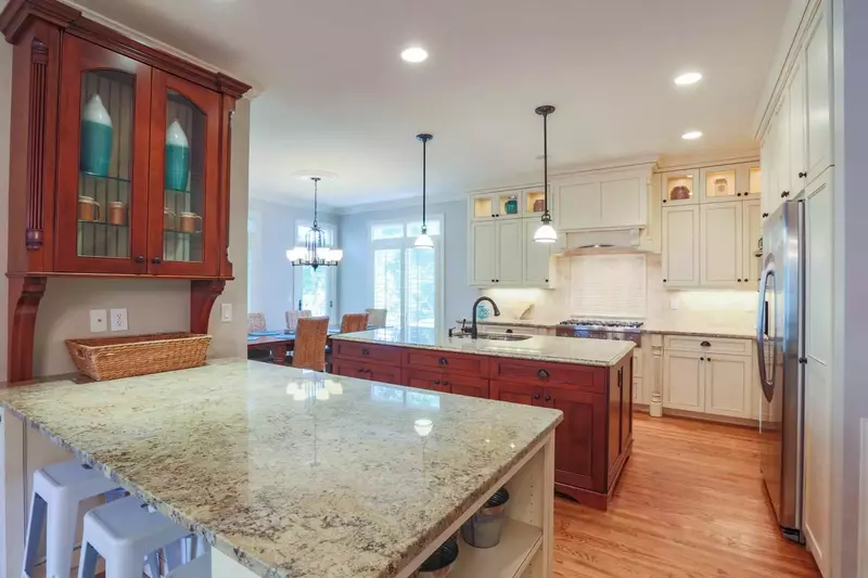 There are three stools on the dining room side of the kitchen counter.