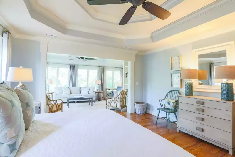 The master suite features a tray ceiling, heart of pine flooring and its own private seating area.