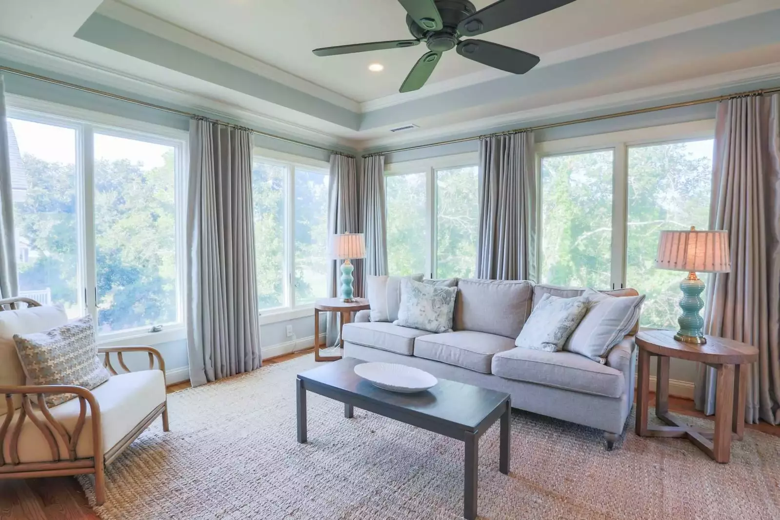 The windows in the seating area overlook the trees separating the back of the house from the 6th fairway of the Links golf course.