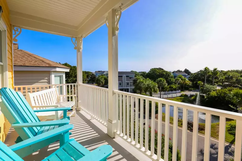 Enjoy cool summer breezes from the second floor porch, which overlooks the Pelican Reach lagoon across the street.