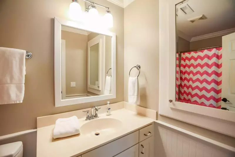 The en suite bathroom for the bunk bedroom has a shower/tub combo.