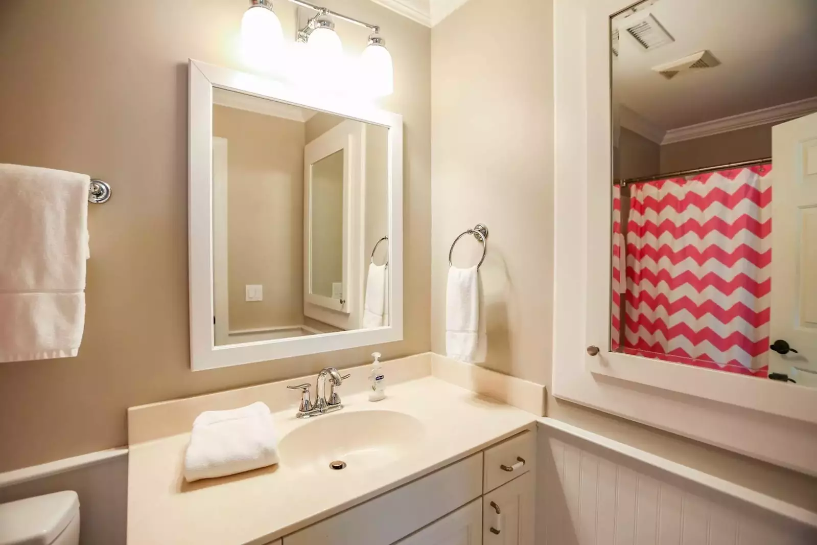 The en suite bathroom for the bunk bedroom has a shower/tub combo.