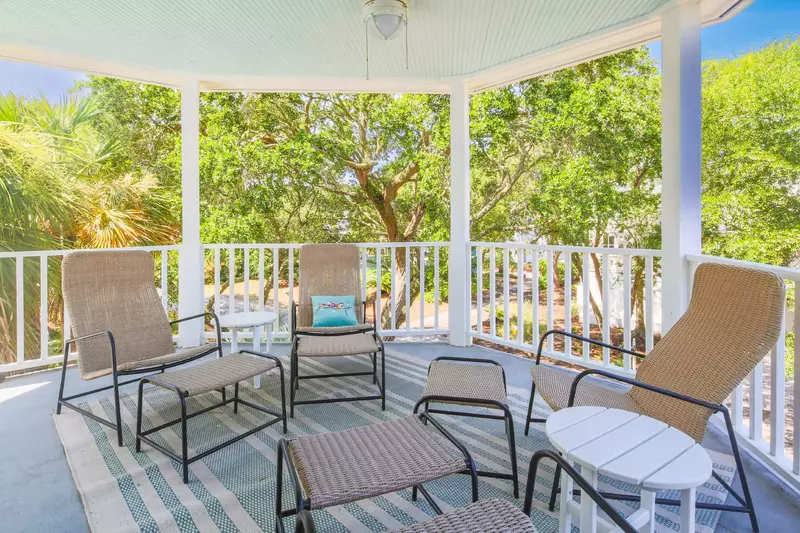 Enjoy this covered balcony with seating area off of the primary suite!