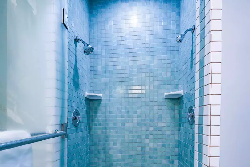 The primary en suite bathroom also has a tiled, walk-in shower.