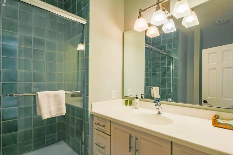 The en suite bathroom features a spacious vanity.