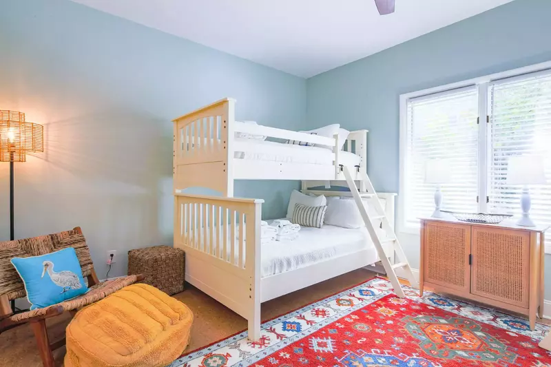 The bunk bedroom features two bunk beds and a seating area.