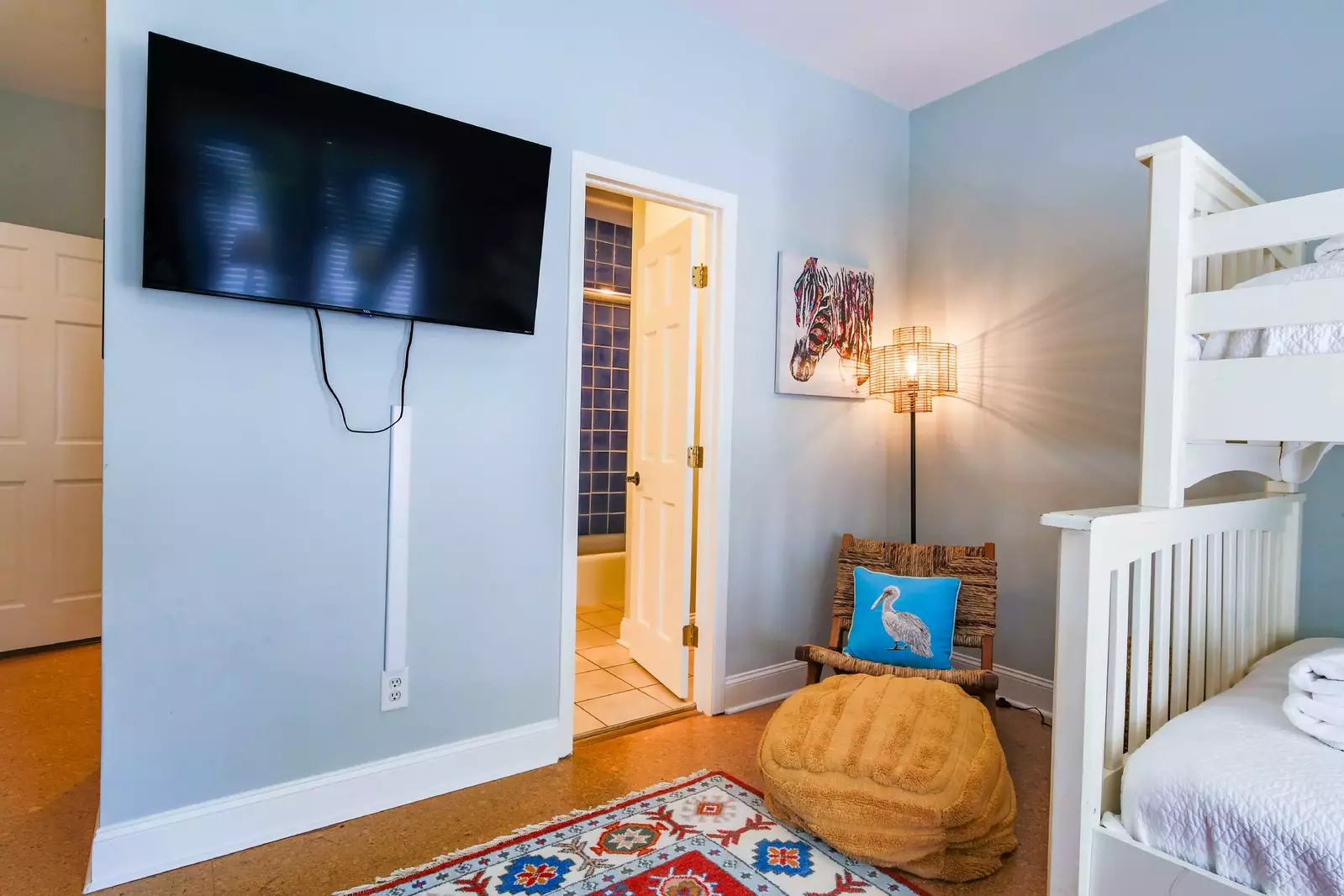 The bunk bedroom also has a wall-mounted TV and access to the shared Jack & Jill bathroom.