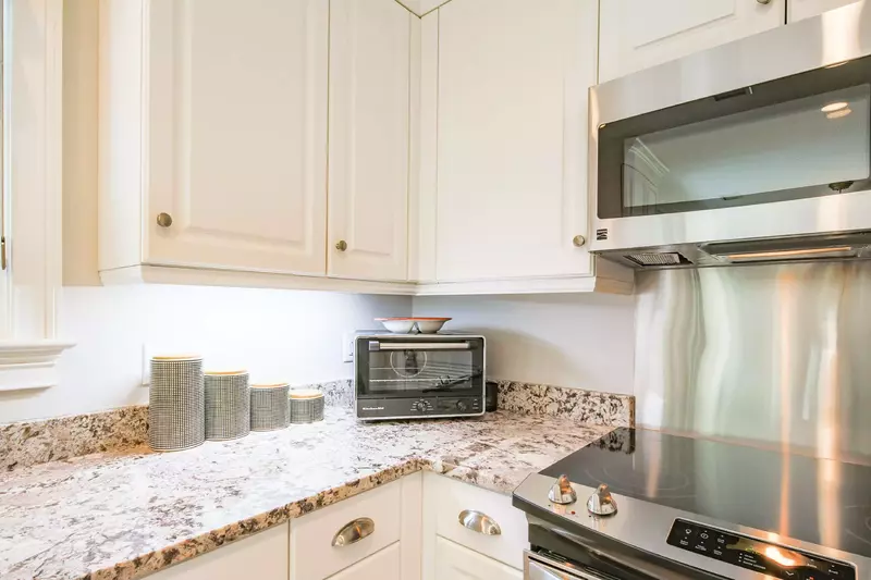 The kitchen features an electric range, microwave and toaster oven.