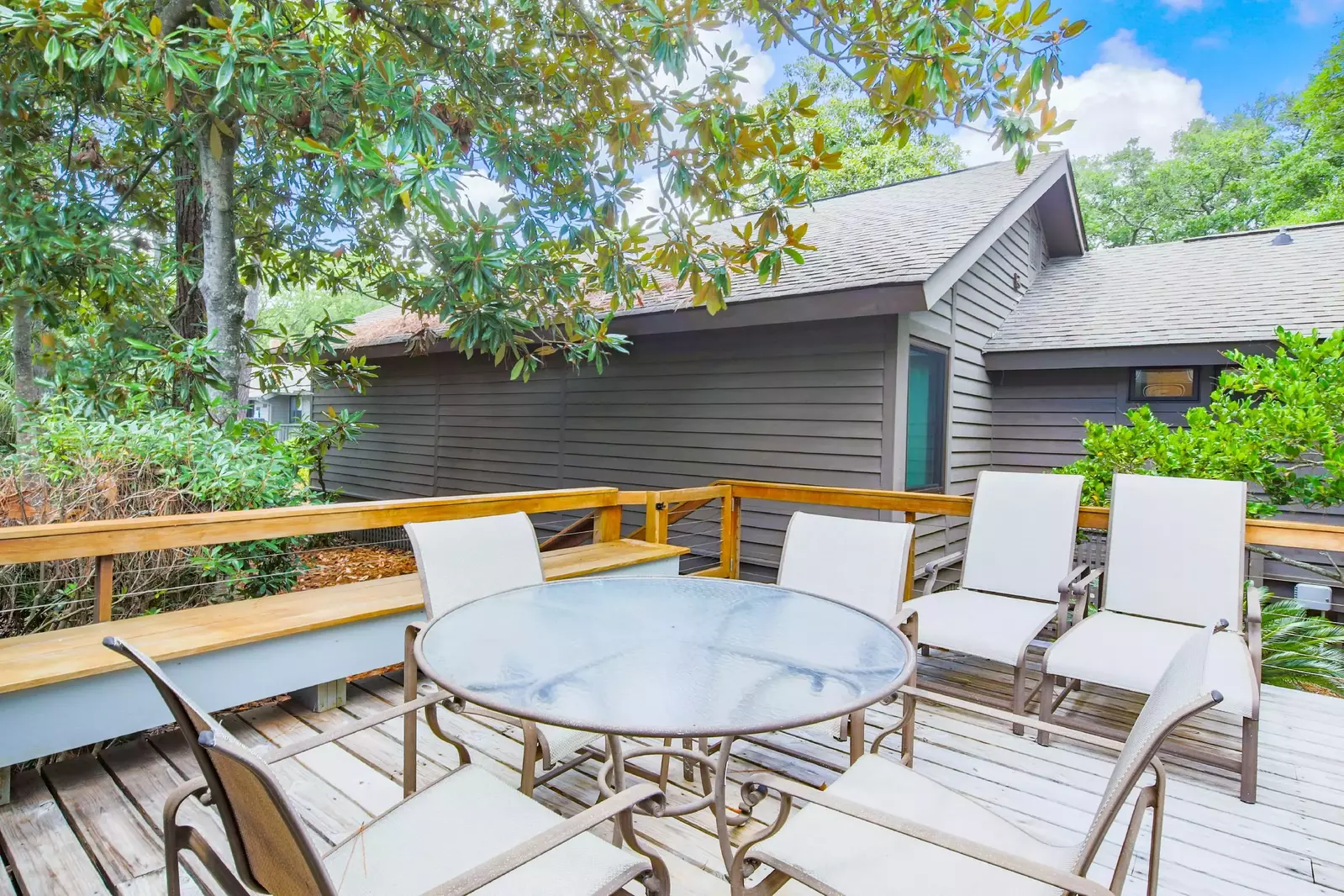 When you step out onto the back deck, you'll find this dining table, bench and lounge seating.